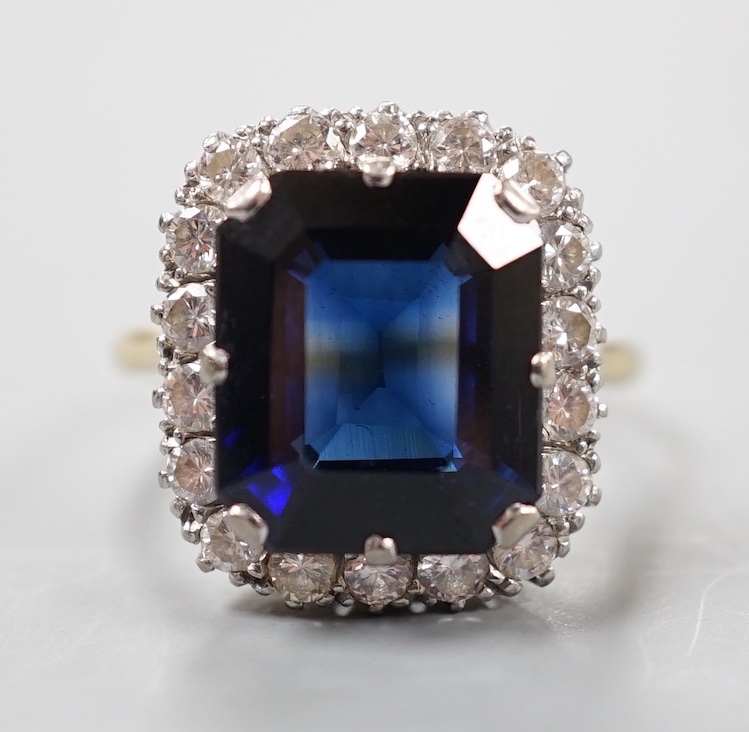 An 18ct, synthetic sapphire and diamond set rectangular cluster dress ring, size T/U, gross weight 10 grams.